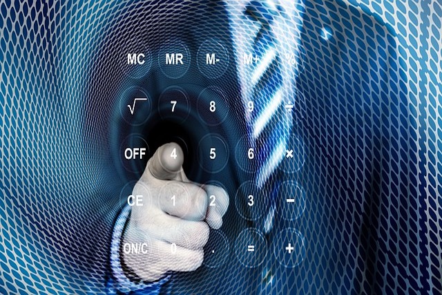 image of businessman pointing at digital calculator feature