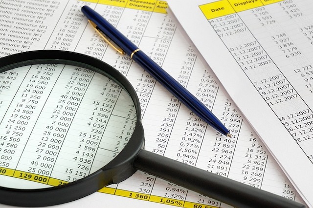 magnifying glass on financial statements feature