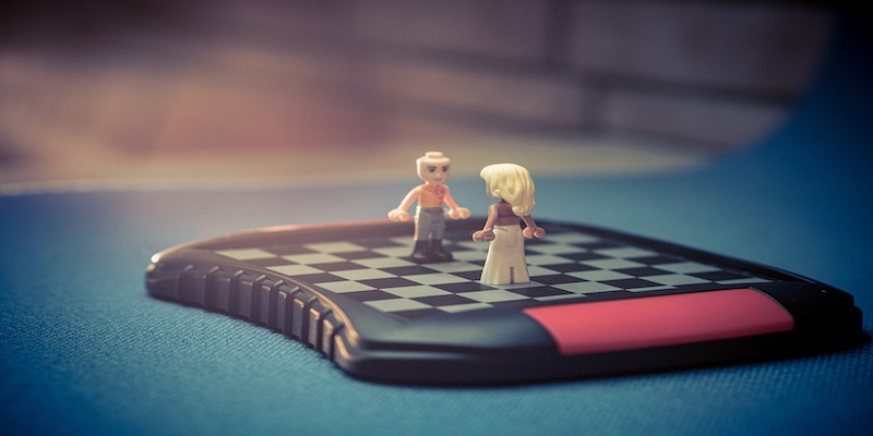 couple on chessboard to signify family disputes